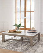 Rectangular cocktail table with white marble-look surface and brown wood base.