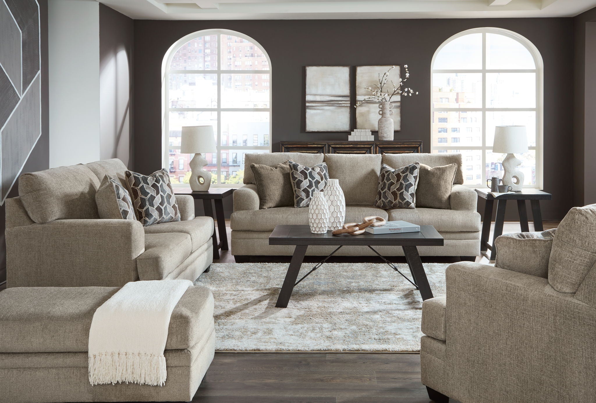 Taupe fabric living room sectional set with ottoman and geometric accent pillows