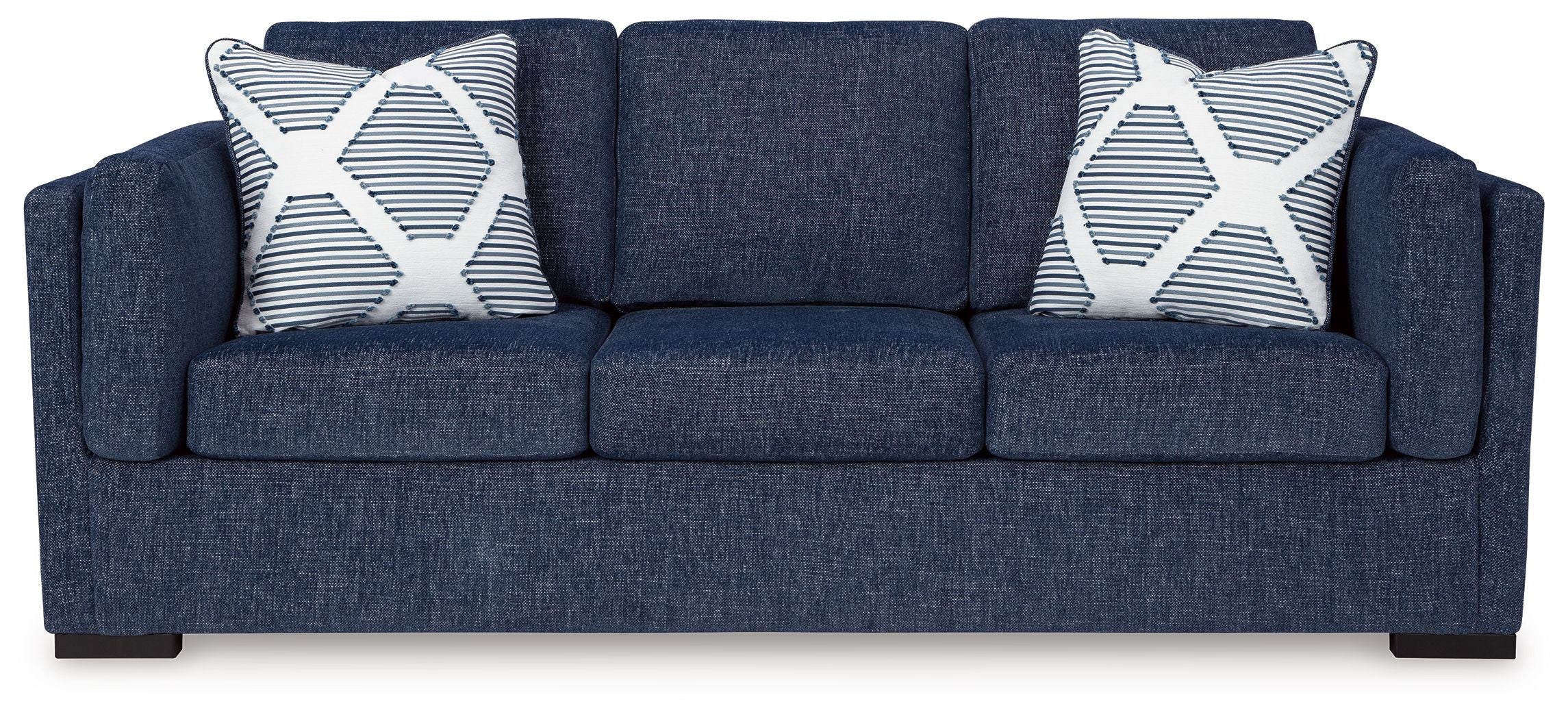 Navy fabric sofa with two patterned throw pillows and three seat cushions