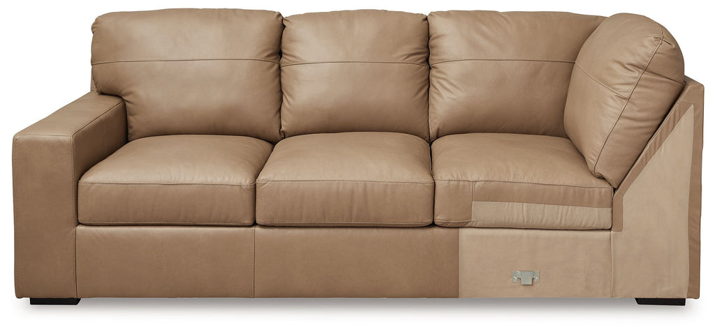 Toffee-brown sectional sofa with deep seats, boxy arms, and button-tufted back cushions