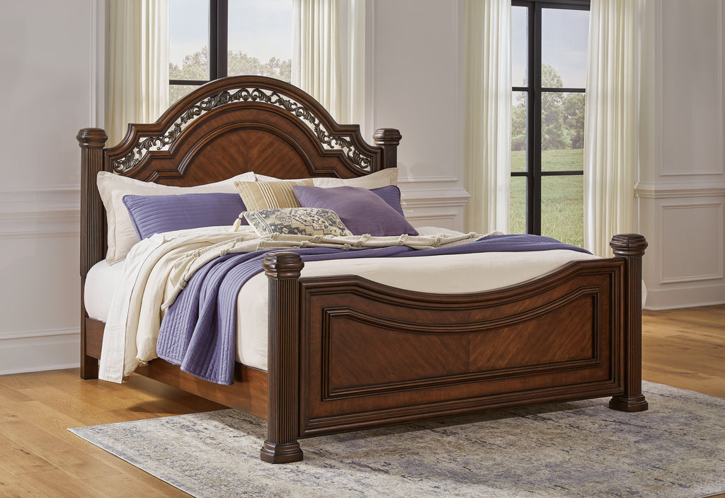 Dark brown poster bed with ornate arched headboard, white bedding and purple coverlet