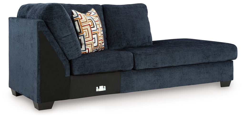 Ink blue corner chaise sofa with left armrest, patterned pillow, and dark feet