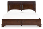 Brown king storage bed with paneled headboard, two drawers, and central support rail