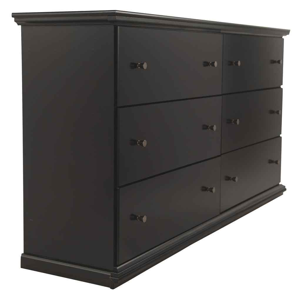 Black wood dresser with six drawers and metal knobs, side view