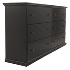 Black wood dresser with six drawers and metal knobs, side view
