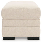 Light beige rectangular ottoman with cushioned lid and black block feet