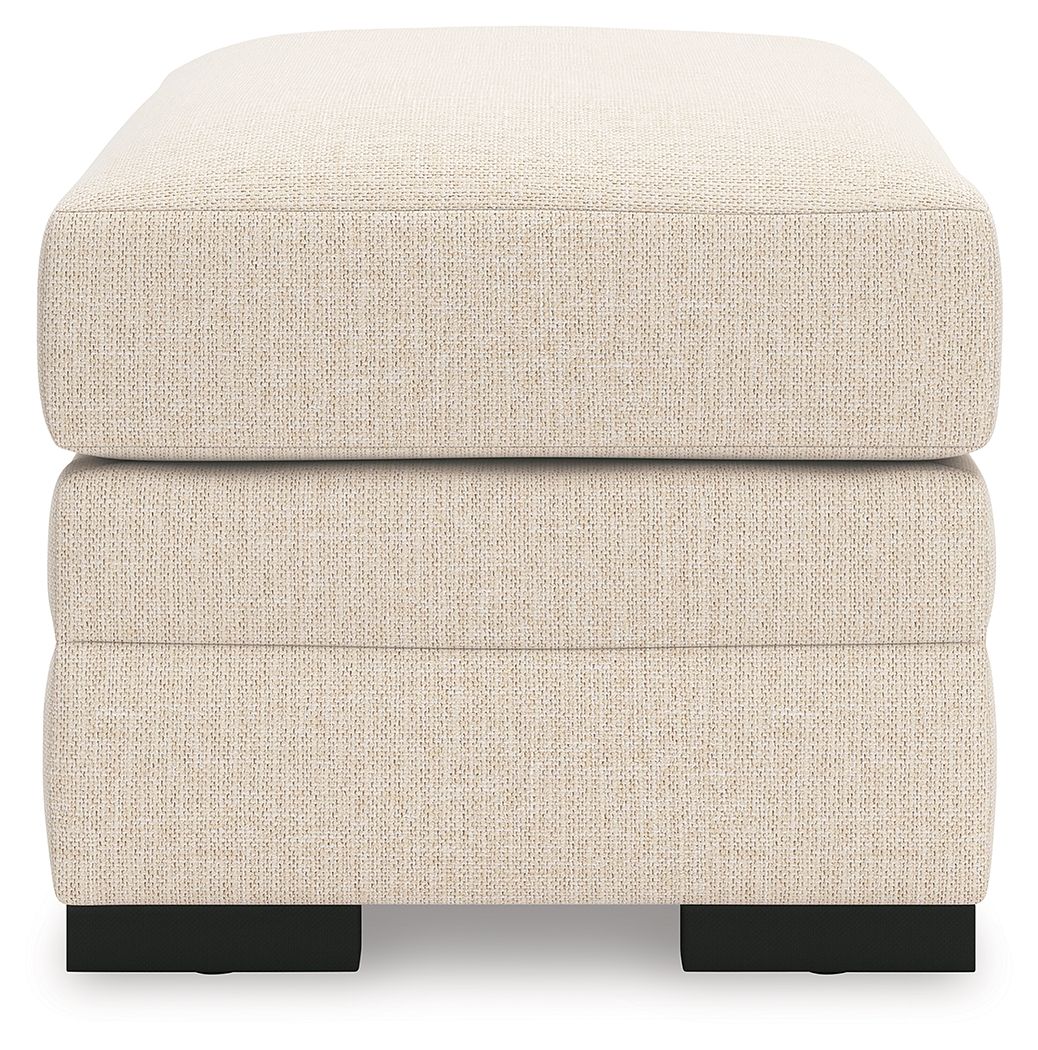 Light beige rectangular ottoman with cushioned lid and black block feet