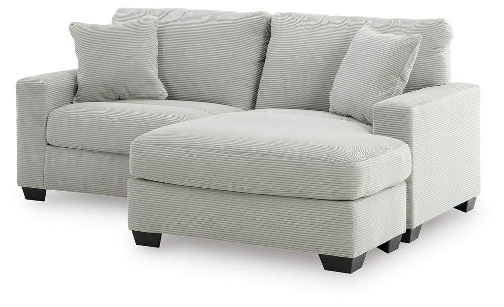 Light gray sofa chaise with rounded chaise ottoman and three back cushions