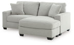 Light gray sofa chaise with rounded chaise ottoman and three back cushions