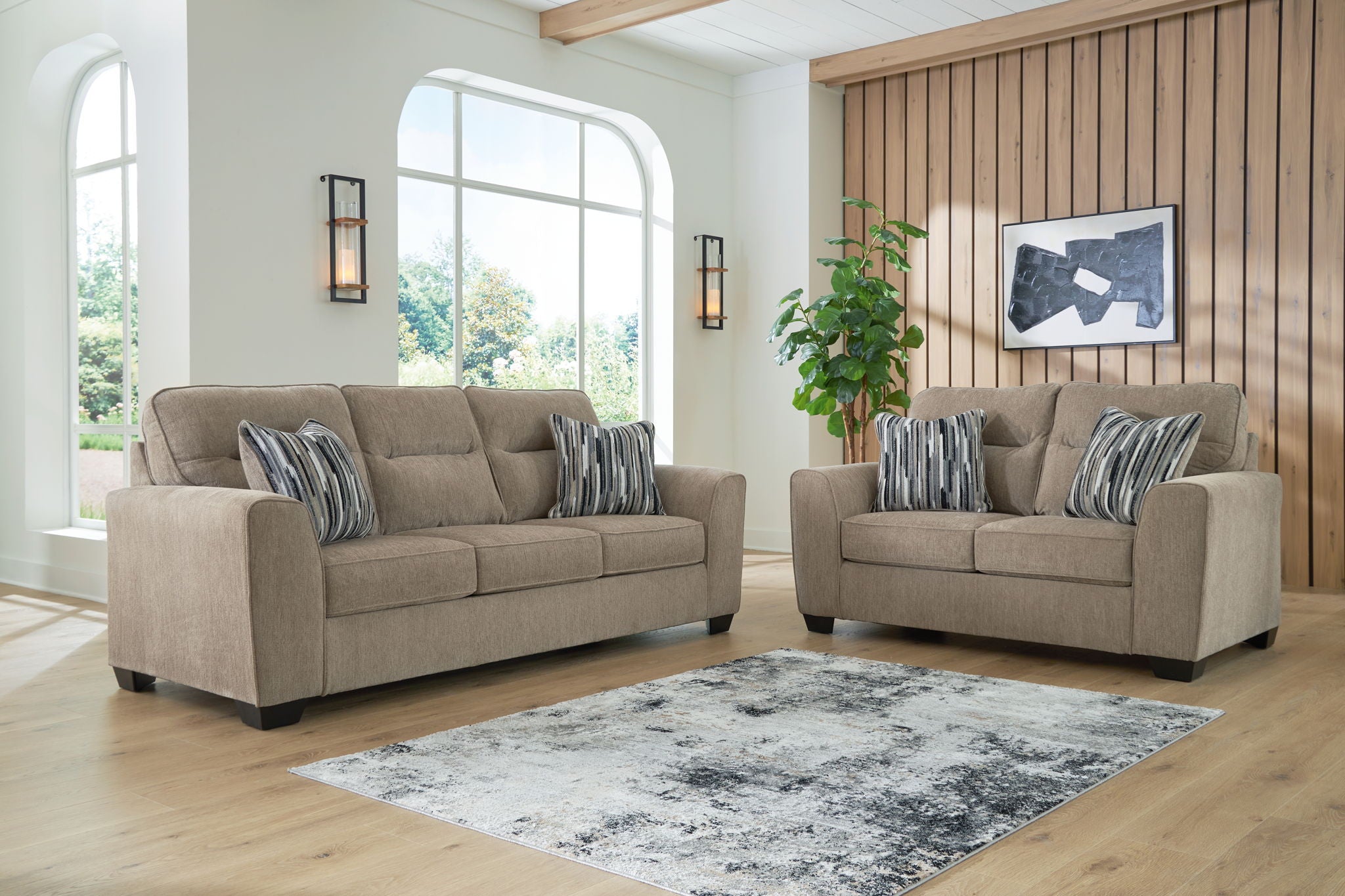 Light brown fabric sofa and chair set with striped throw pillows