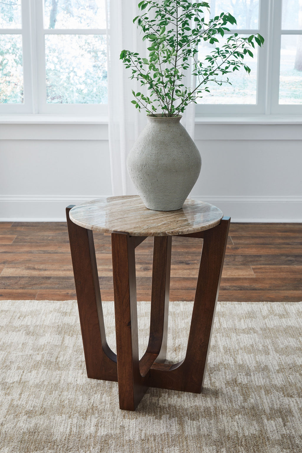 Warm brown round end table with round top and four curved legs