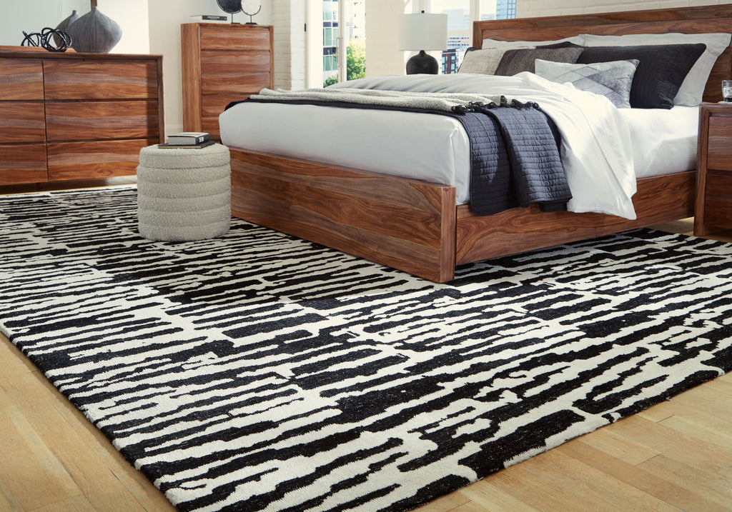 Black-and-white abstract striped area rug laid flat on the floor