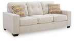 Queen sofa sleeper with beige upholstery and two patterned throw pillows