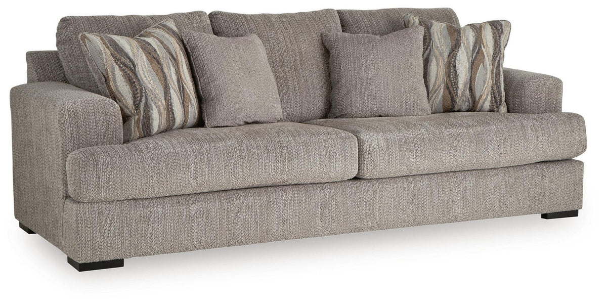 Gray fabric sofa with three seat cushions and patterned accent pillows