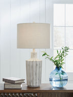 Imre poly table lamp with beige drum shade and distressed gray base