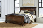 Dark brown panel bed frame with paneled headboard and footboard, linen-covered mattress