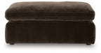 Dark brown upholstered ottoman with padded top cushion and short legs