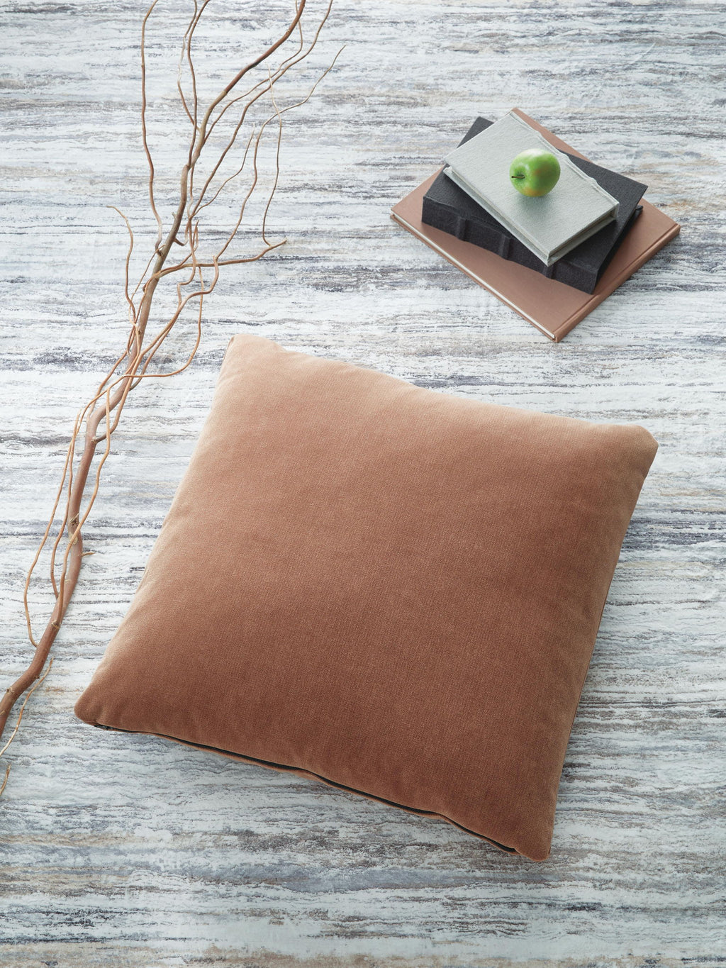 Light brown square throw pillow with smooth fabric and stitched edges