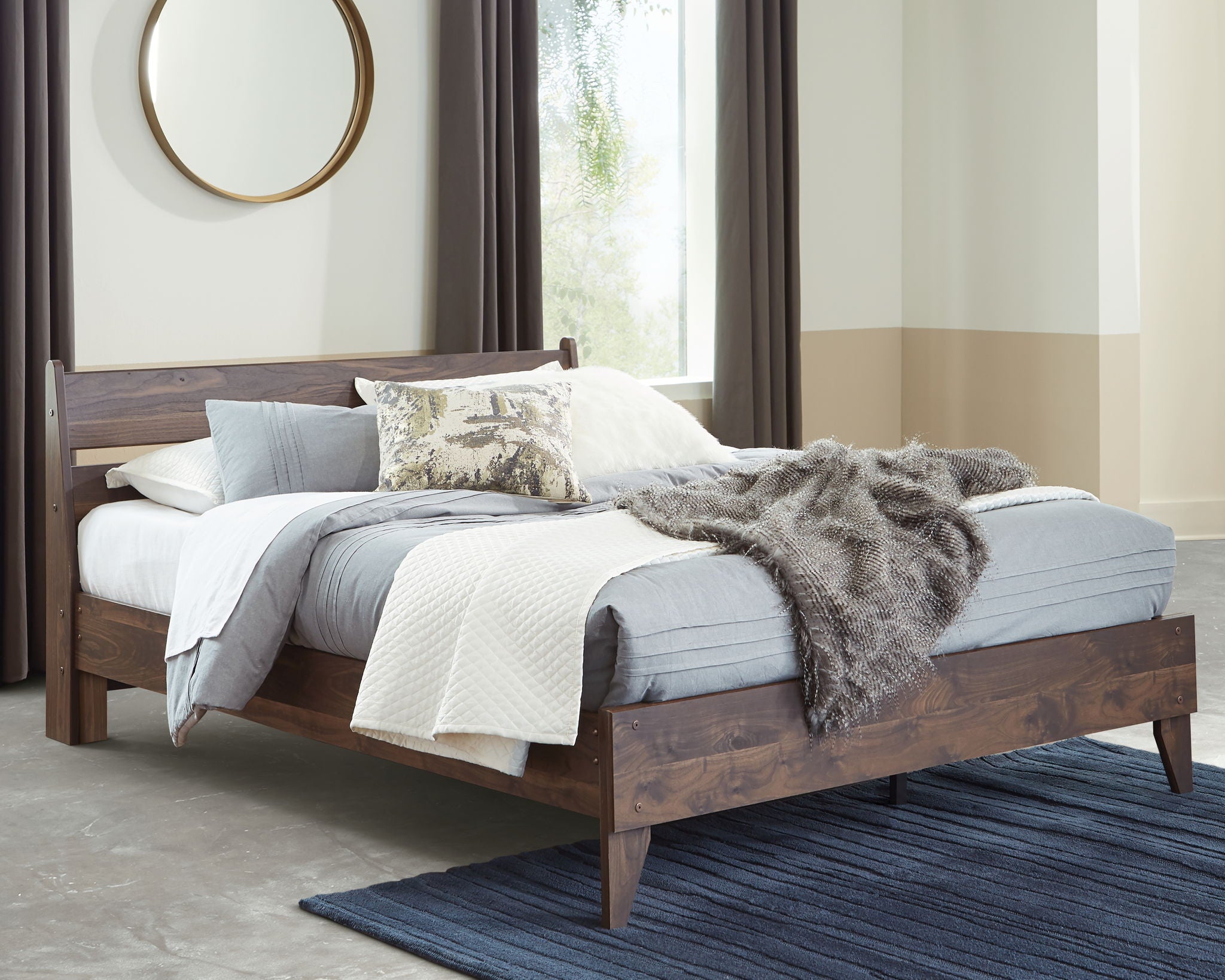 Light brown platform bed with white bedding, paneled headboard and wood footboard