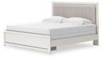 White upholstered panel bed with tall channel-tufted headboard and two white pillows