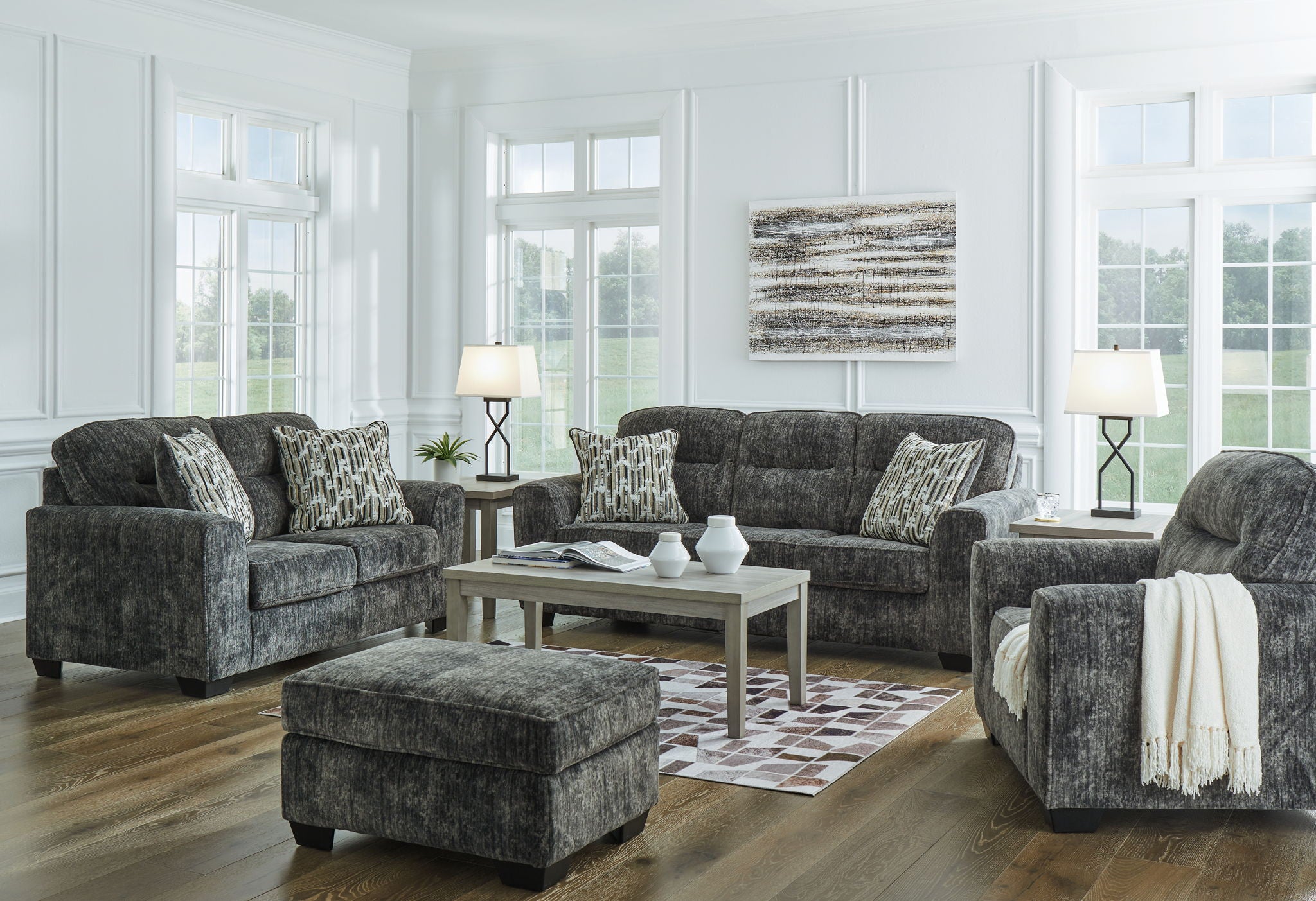 Dark gray living room seating set with sofa, chair, and ottoman