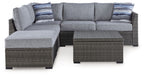 Gray sectional loveseat set with two corner ottomans and rectangular coffee table