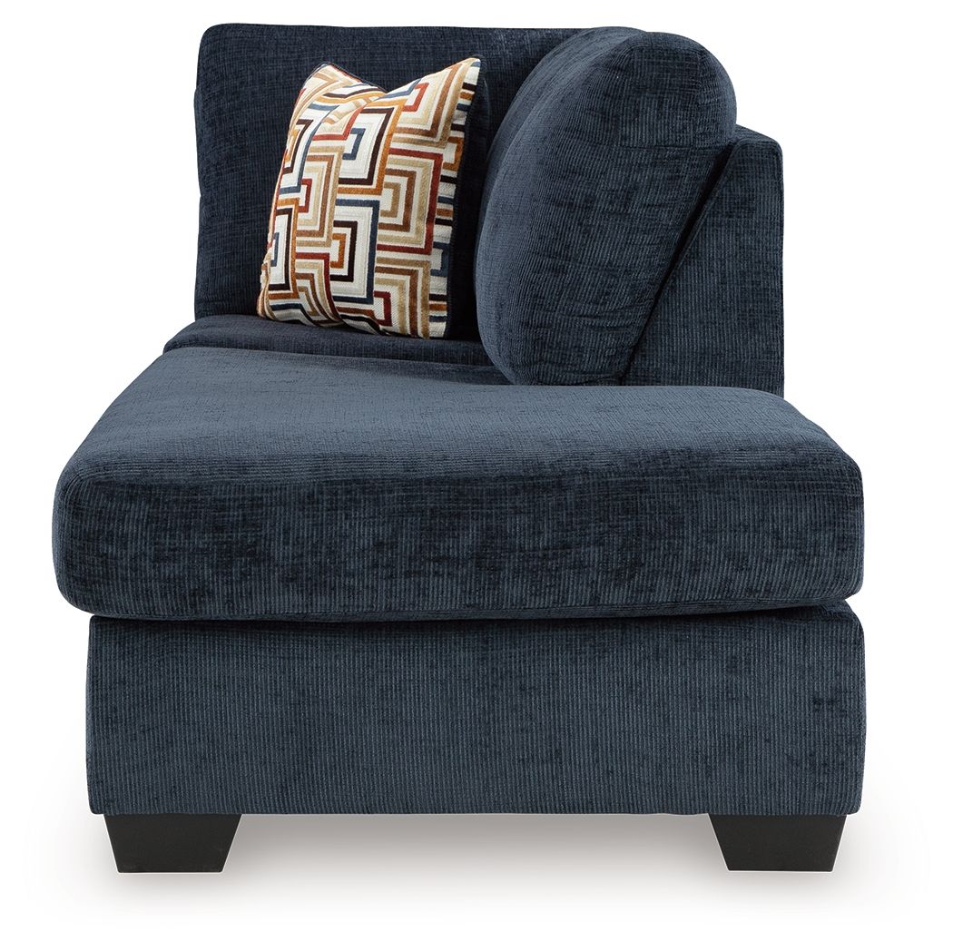 Ink blue corner chaise sofa arm section with patterned accent pillow