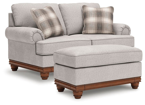 Upholstered loveseat with ottoman, beige fabric, plaid throw pillows, dark wood legs
