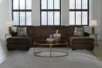 Chocolate sectional sofa with two chaise seats and patterned accent pillows, centered view