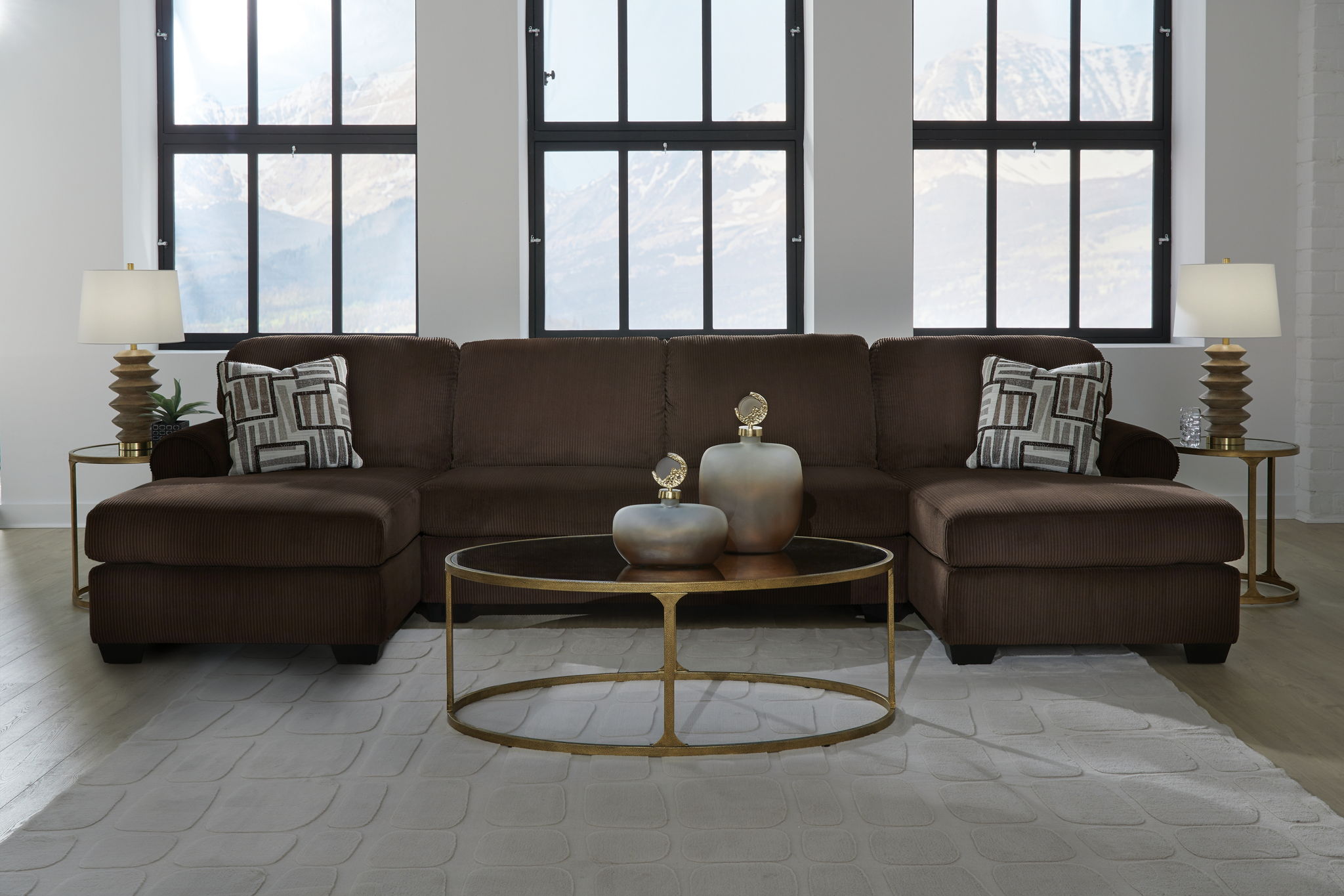 Chocolate sectional sofa with two chaise seats and patterned accent pillows, centered view