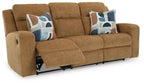Honey reclining sofa with extended footrest, two patterned throw pillows