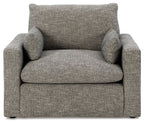 Gray upholstered single chair with two back pillows and padded armrests