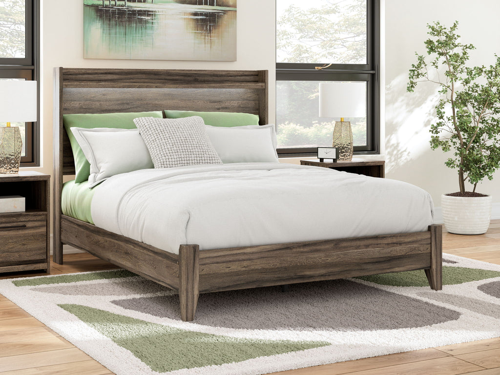 Panel bed with dark brown wood frame, white bedding and green accent pillows