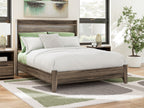 Panel bed with dark brown wood frame, white bedding and green accent pillows