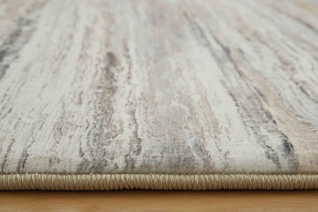 Nace rug close-up with cream base and gray textured distressed stripes