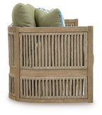 Outdoor sofa backrest with green pillows, beige slatted sides, and striped bolster