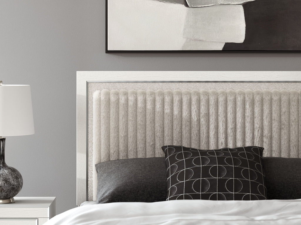 Upholstered panel headboard with textured light fabric and dark pillows