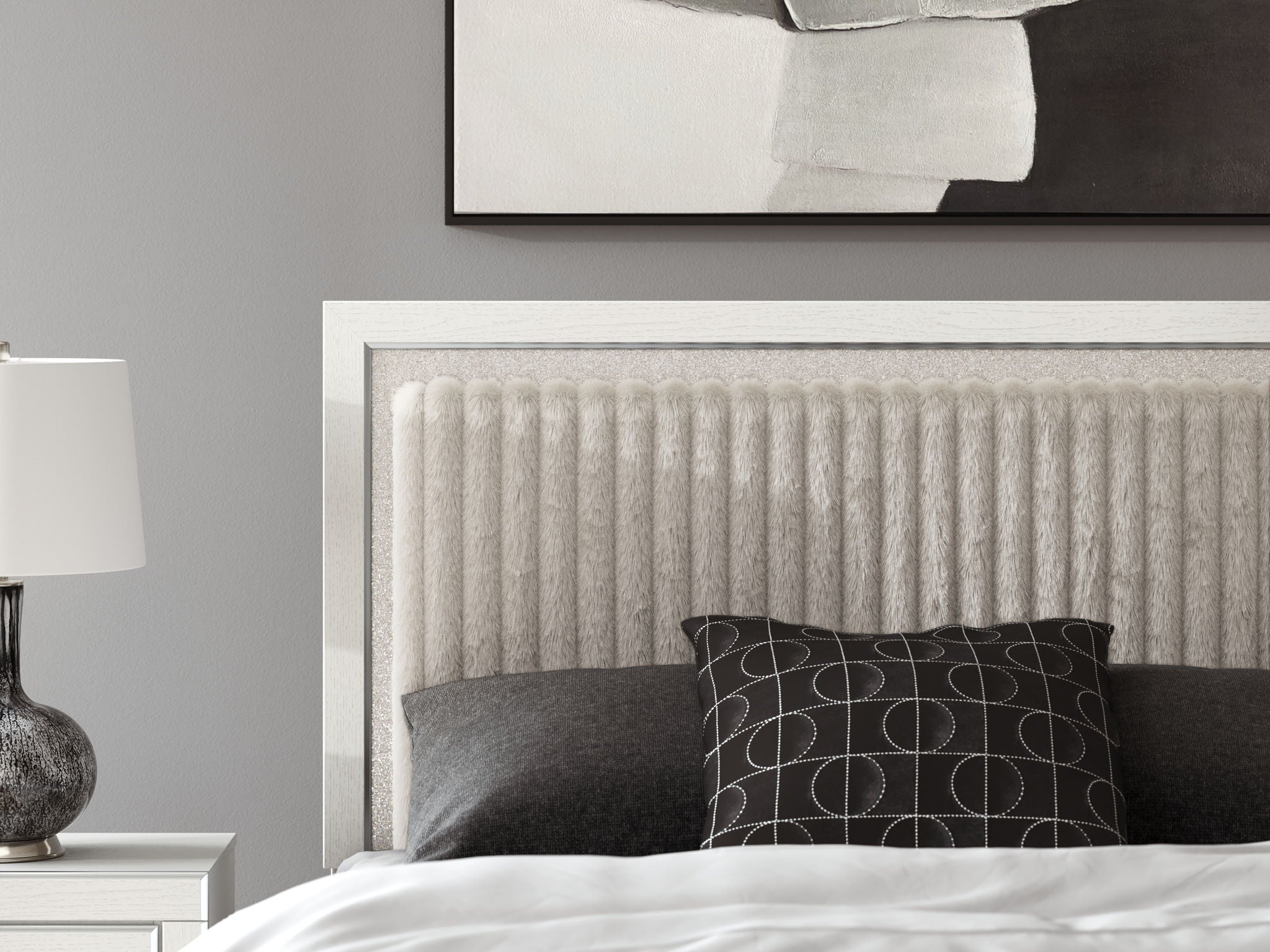 Upholstered panel headboard with textured light fabric and dark pillows