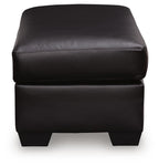 Glennbre ottoman close-up, dark padded upholstery, double-row stitching, short legs