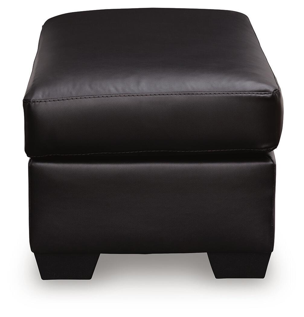 Glennbre ottoman close-up, dark padded upholstery, double-row stitching, short legs
