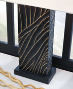 Black table lamp base with gold vein-like pattern under white fabric shade