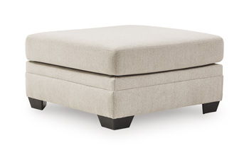 Beige upholstered ottoman with square top and dark angled legs