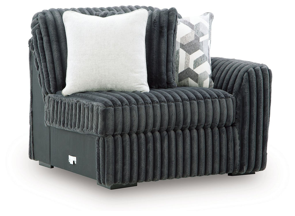 Gunmetal corduroy corner chair with white accent pillow and vertical channel quilting