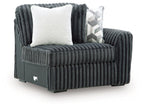 Gunmetal corduroy corner chair with white accent pillow and vertical channel quilting