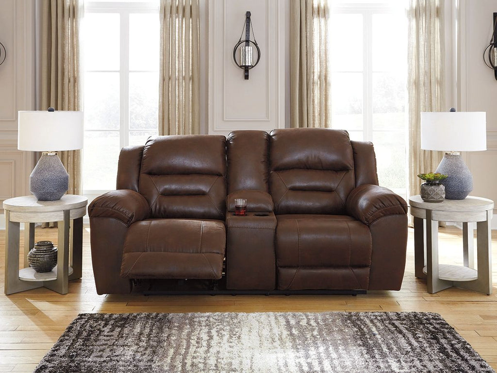 Reclining loveseat in medium-dark brown leather with padded back cushions and recline headrests