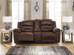Reclining loveseat in medium-dark brown leather with padded back cushions and recline headrests