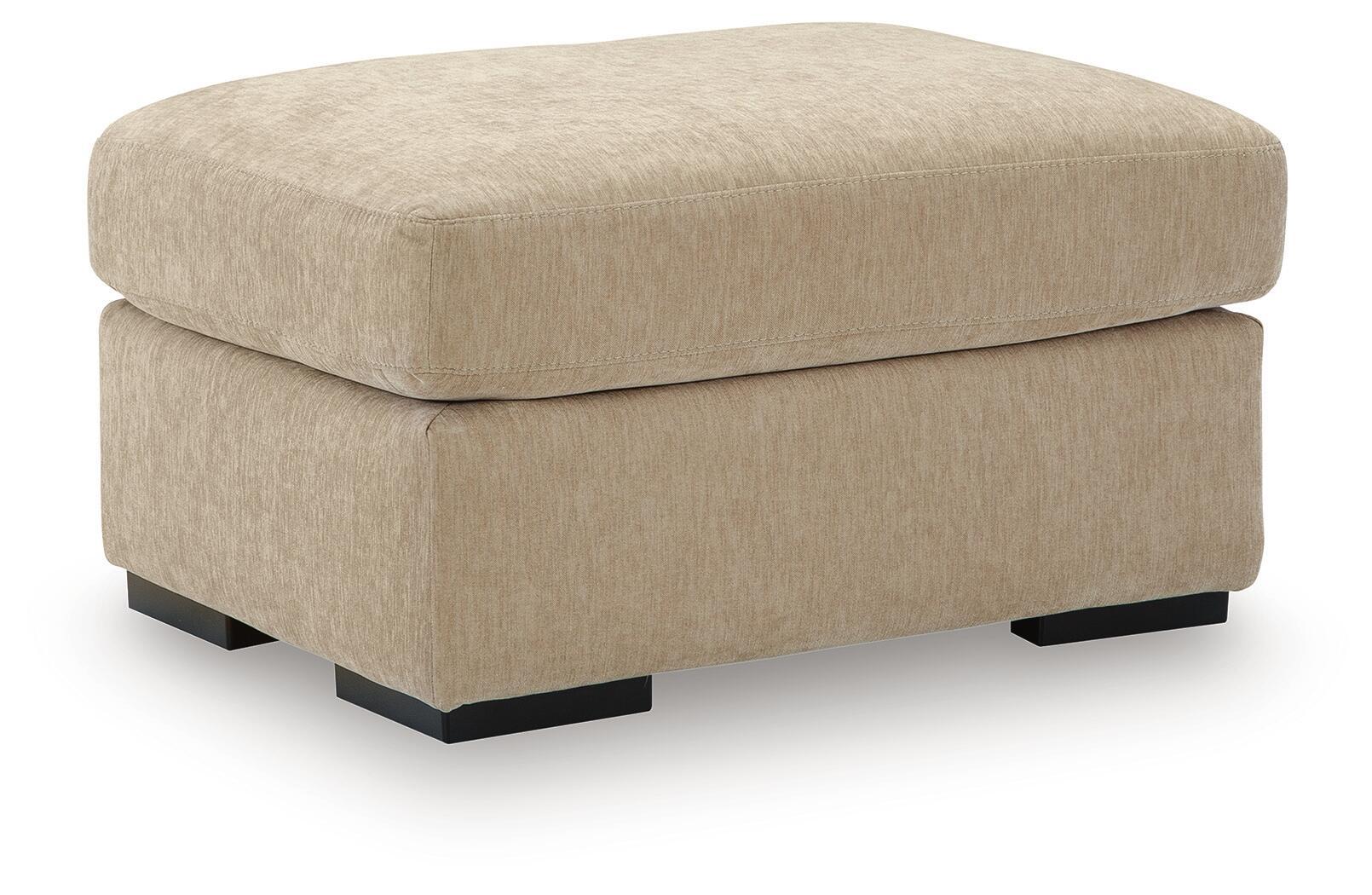Light brown fabric ottoman with rounded seat, thick sides, and black legs