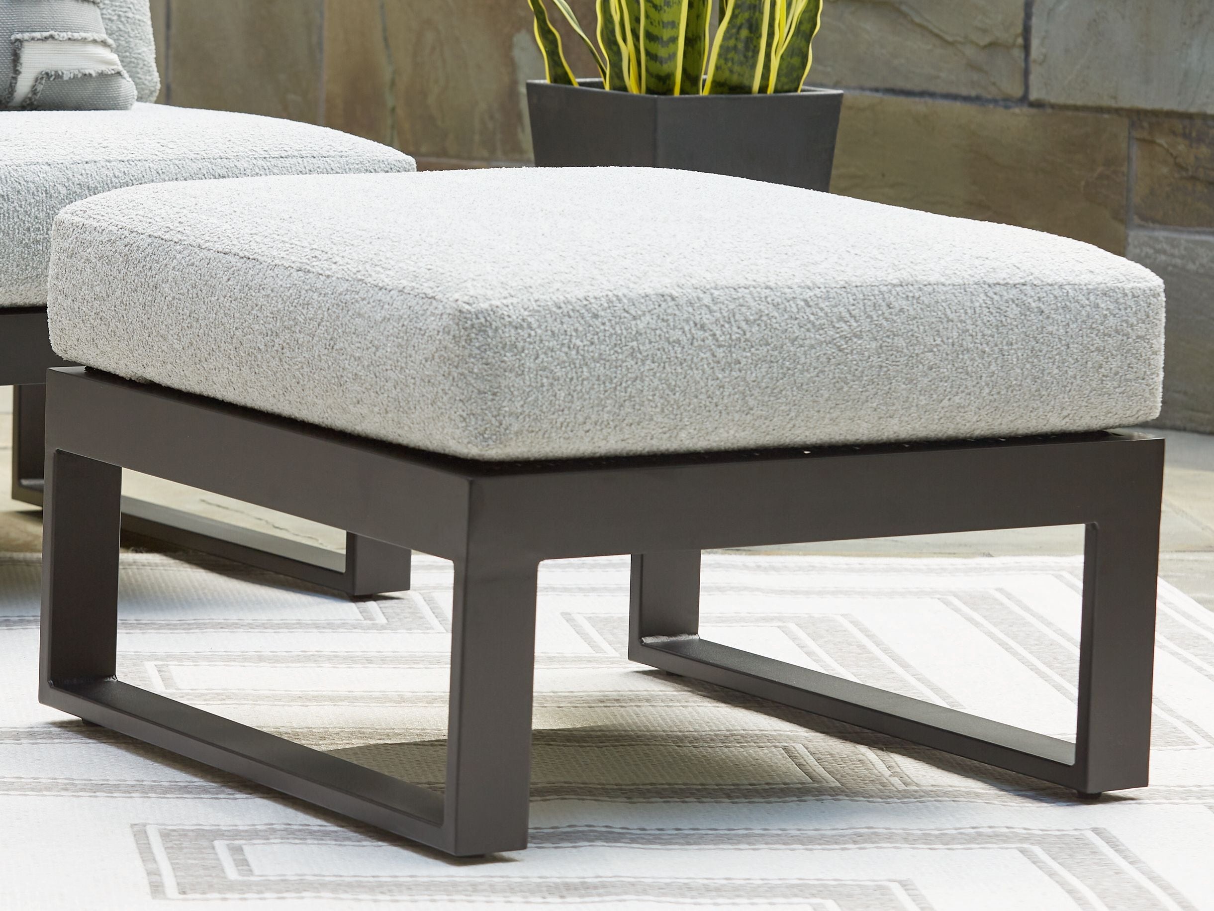 Ottoman with cushion, light gray upholstery on dark wood-like frame