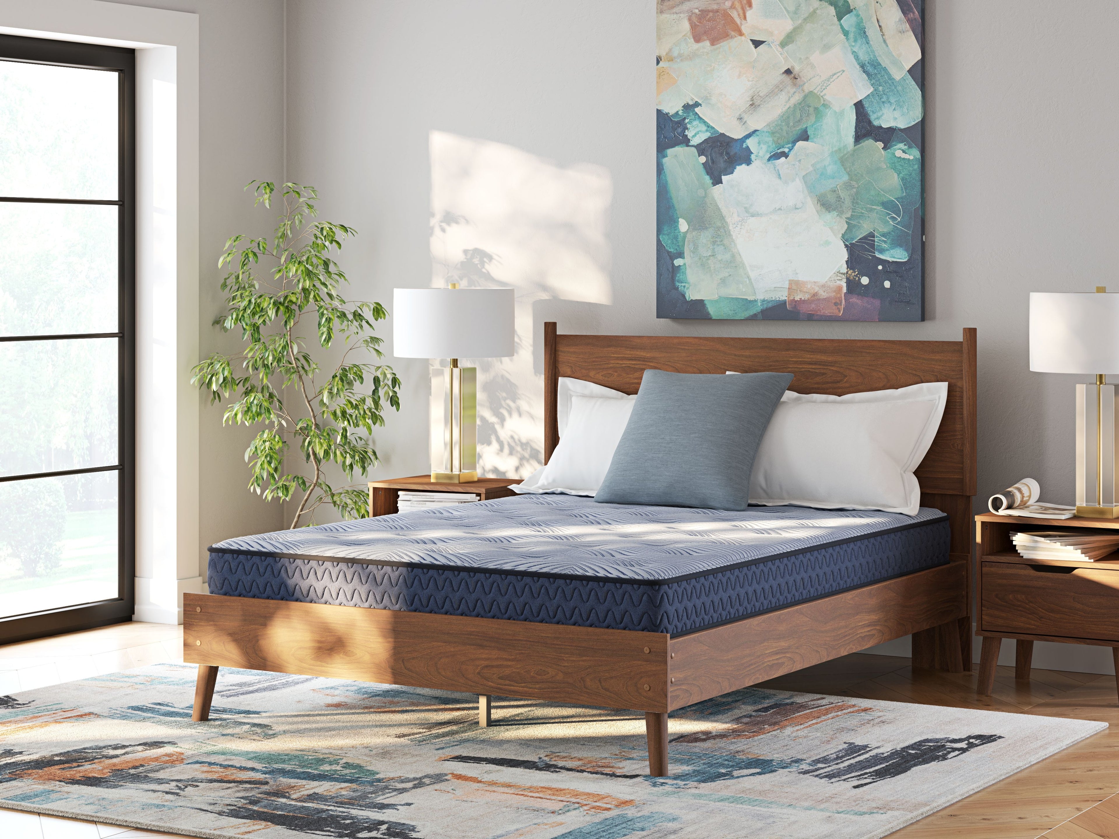 Blue mattress on wooden bed frame with pillows