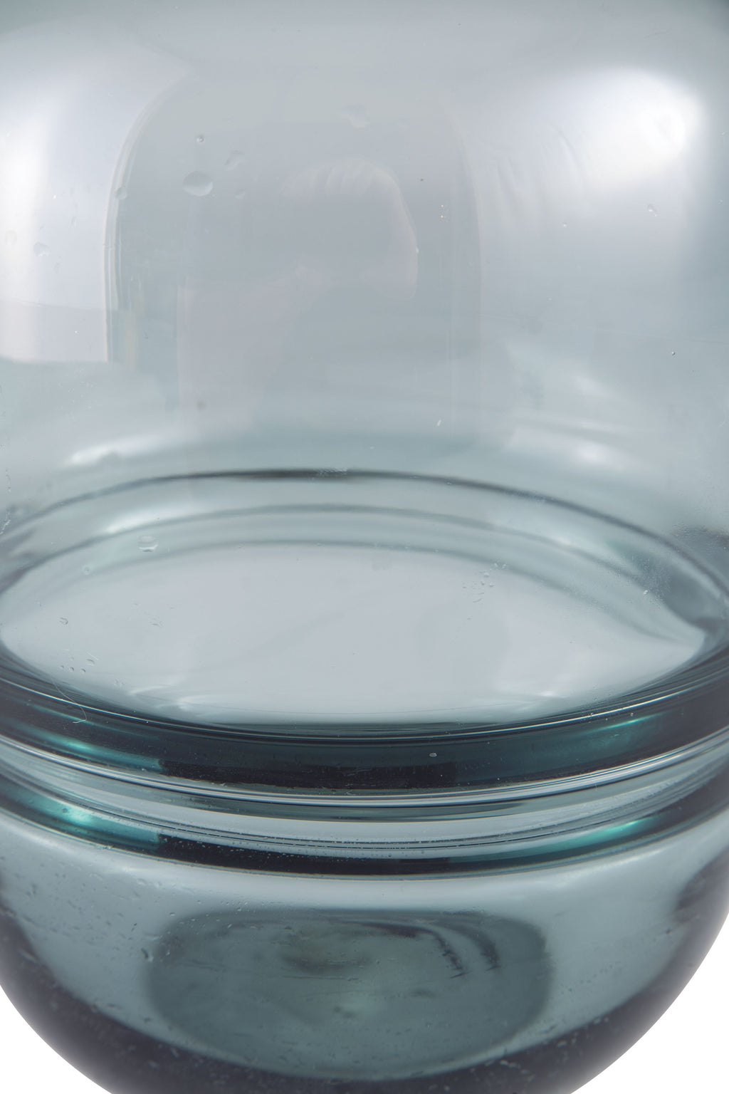 Teal glass vase opening view, smooth rim and translucent curved sides.
